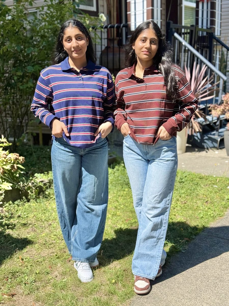 Harpreet standing outdoors in a striped top and jeans