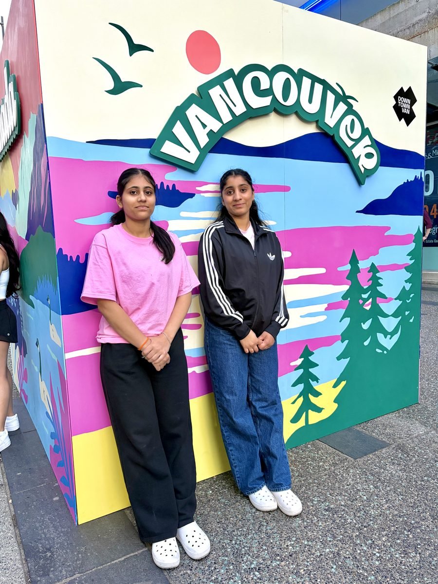 Harpreet in front of a colourful Vancouver mural